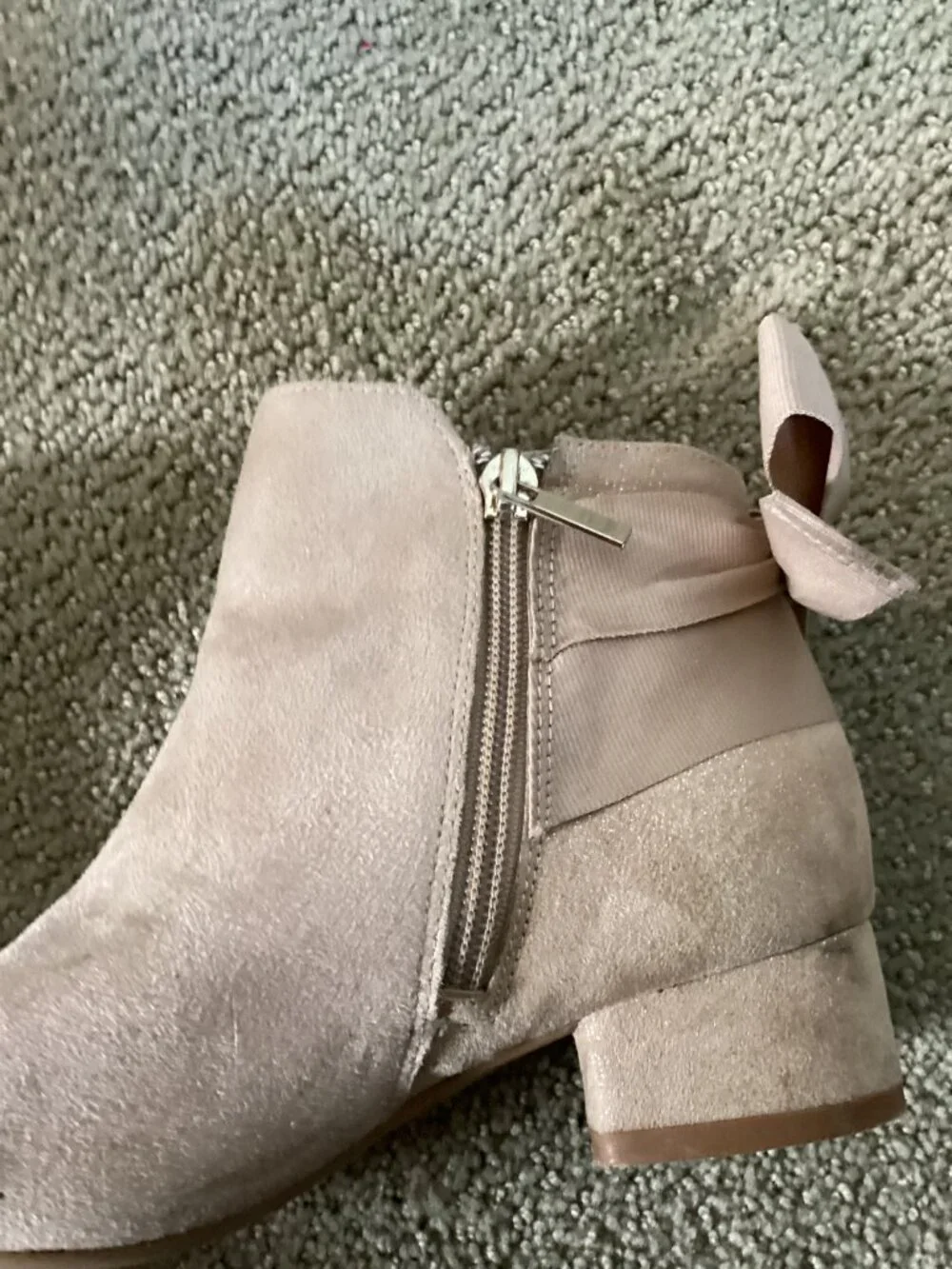 Heels for kids with bow on back of shoe.